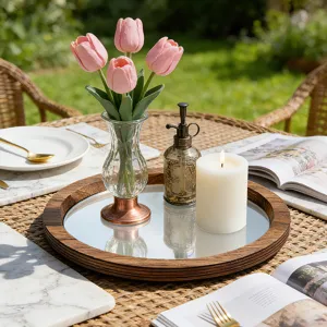 Détail en gros plan du plateau miroir en bois décoré de tulipes et d'une bougie.