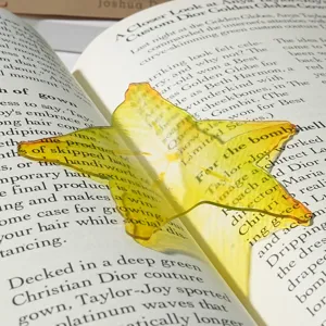 Translucent acrylic starfruit bookmark detail, vibrant yellow fruit design for student reading.