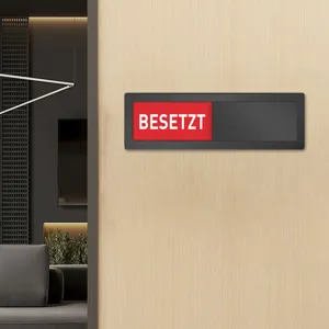 Detail shot of acrylic magnetic status indicator sign for office door, red occupied text.