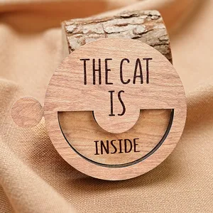 Detailed close-up view of the wooden rotatable pet status sign featuring engraved text.