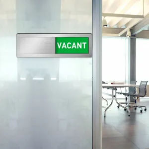 Detailed view of sliding office door sign with vacant status indicator on frosted glass.