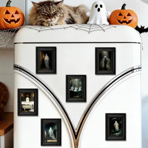Detail view of Halloween ghost magnetic photo frames on a retro white refrigerator.