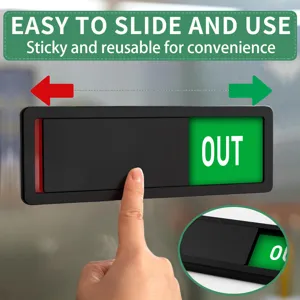 Close-up view of the sliding status sign showing the green out indicator clearly.