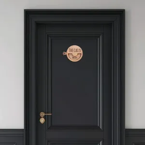 Detail view of wooden magnetic pet status sign mounted on door, showing sliding mechanism.