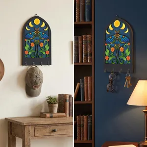 Bohemian wooden key holder wall decor featuring moth moon and floral design with metal hooks.