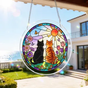 Detailed shot of the stained acrylic cat suncatcher hanging in sunlight for window decor.