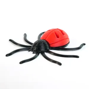 Detailed macro view showing the 3D printed texture of the red and black spider fridge magnet.