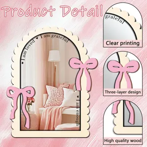 Wooden arch mirror detail showing natural wood frame, pink bows, and clear reflection.
