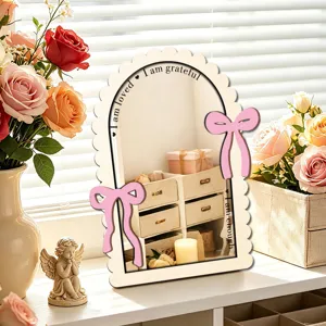Wooden arched decorative mirror with pink bows tabletop home bedroom decor detail closeup