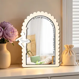 Wooden arched mirror detail with ballerina silhouette and inspirational quotes for room decor.