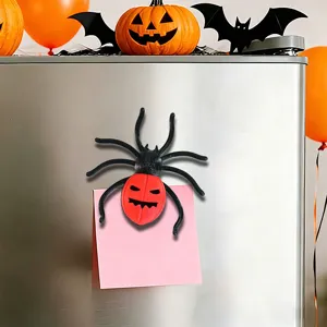Close-up view of 3D printed Halloween spider fridge magnet holding memo note on the refrigerator.