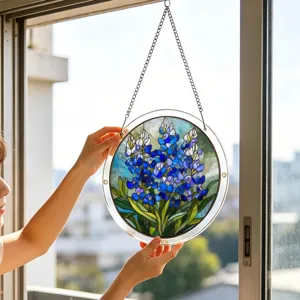 Acrylic suncatcher window hanging with blue floral design, beautiful light catching home decor.
