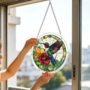 Detailed view of the stained acrylic hummingbird window hanging suncatcher with colorful flowers.