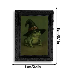 Close-up detail of vintage black picture frame fridge magnet featuring a witch frog painting.