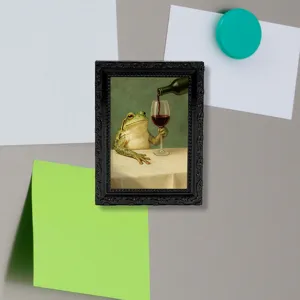 Detail view of a vintage frog painting fridge magnet in a black frame, perfect for home decor.