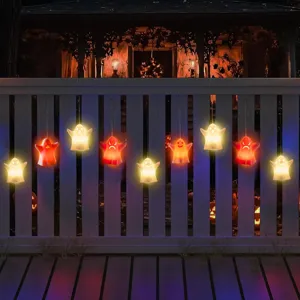 Detailed view of glowing Halloween ghost LED hanging lights on white fence for holiday decor.