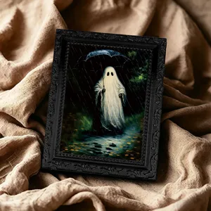 Close-up of Halloween ghost picture frame magnet featuring spooky rain art on draped fabric.