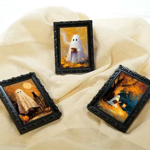Detailed close-up of mini vintage magnetic photo frames featuring cute Halloween ghost art.