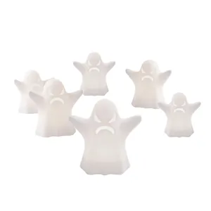 Close-up details of glowing ghost LED decor lights, white angry expression, Halloween party style.