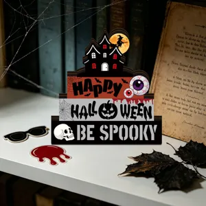 Detailed view of wooden Halloween layered table decoration with spooky ghost house and pumpkin.