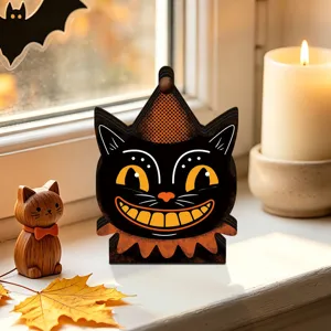 Detailed shot of vintage Halloween wooden cat ornament on a cozy windowsill with warm candle.