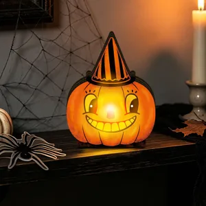 Detailed view of the retro wooden lighted Halloween pumpkin tabletop decoration creating cozy vibes.