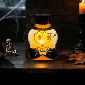 Detailed view of vintage Halloween wooden glowing skull ornament with top hat and warm light.