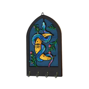 Bohemian wooden key holder wall mount with mystic snake moon eye design and four metal hooks.