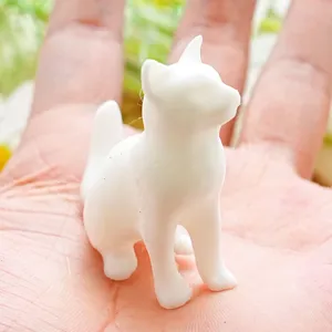 Detail shot of a white 3D cat fridge magnet showing its compact size and cute sitting posture.