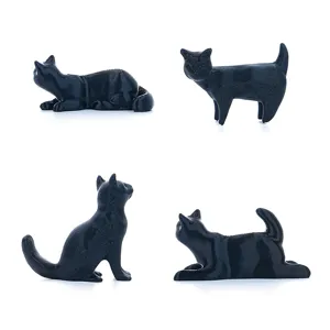 Detailed close-up showing four different dynamic poses of black 3D printed cat magnetic stickers.