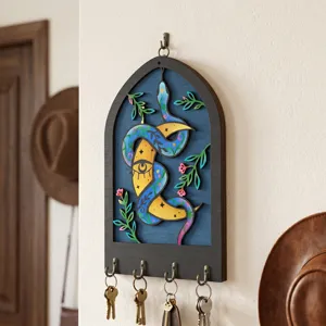 Bohemian wooden key holder wall decor with snake and celestial moon eye design for entryway.