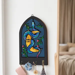Bohemian wooden key holder wall decor with mystical snake moon art and hooks for hanging.