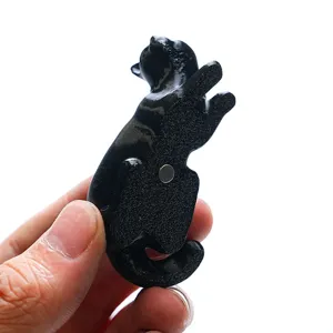 Close-up detail view of the black 3D printed cat fridge magnet with strong back magnet.