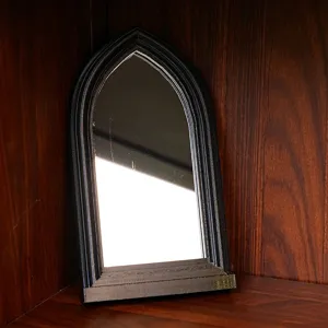 Gothic arched mirror detail view, vintage black decorative window frame for home interior.