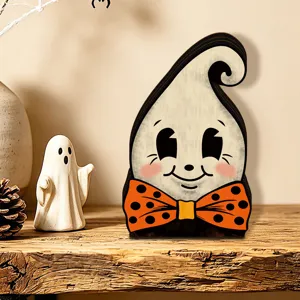 Close-up view of the vintage wooden ghost tabletop decor with orange polka dot bow tie.