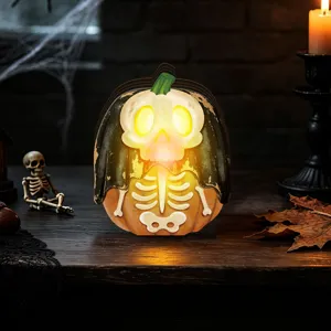 Halloween wooden glowing pumpkin ornament detail, spooky tabletop decoration with LED light.