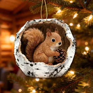 Close-up of a cute squirrel tree hole Christmas ornament hanging on a festive pine tree branch.