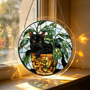 Close-up detail view of stained glass style acrylic black cat suncatcher hanging by window.