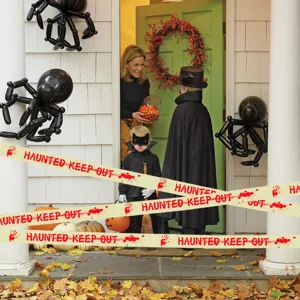 Detailaufnahme von Halloween Warnband mit blutigen Handabdrucken und auffälligem Text vor Ort.