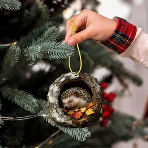 Close-up detail view of the cute sleeping hedgehog in tree hole acrylic ornament hanging nicely.