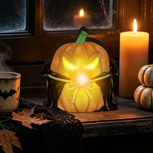 Halloween glowing pumpkin wooden ornament detail with cozy candle light background view.