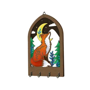 Detailed view of the wooden key holder featuring a boho forest fox and moon design with metal hooks.