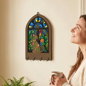 Detailed view of bohemian wooden key holder, cat wall decor hook rack with arch window design.