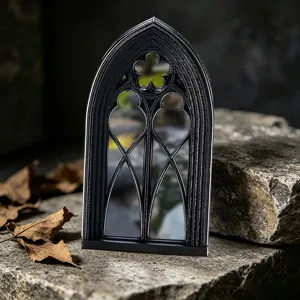 Gothic window mirror detail, black arched frame decor, vintage home ornament close up.