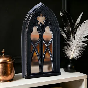 Gothic window mirror detail shot showcasing intricate arched frame design and dark aesthetic.