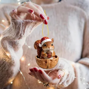 Charming Christmas squirrel hanging ornament in walnut shell, perfect for holiday tree decor.