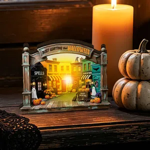 Close-up detail of the glowing wooden Halloween village decoration with festive miniature streets.