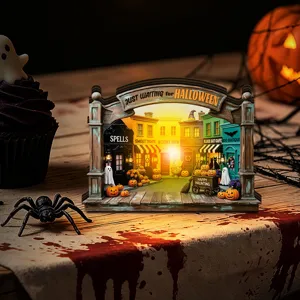 Detailed Halloween light-up wooden miniature street scene desktop decoration with warm glow.