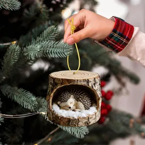 Cute sleeping hedgehog tree hole Christmas ornament with snow for holiday tree hanging decor.