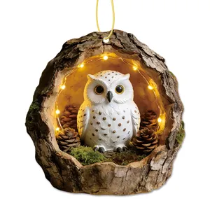 Close-up detail of the resin hollow tree owl hanging ornament featuring warm LED lights.